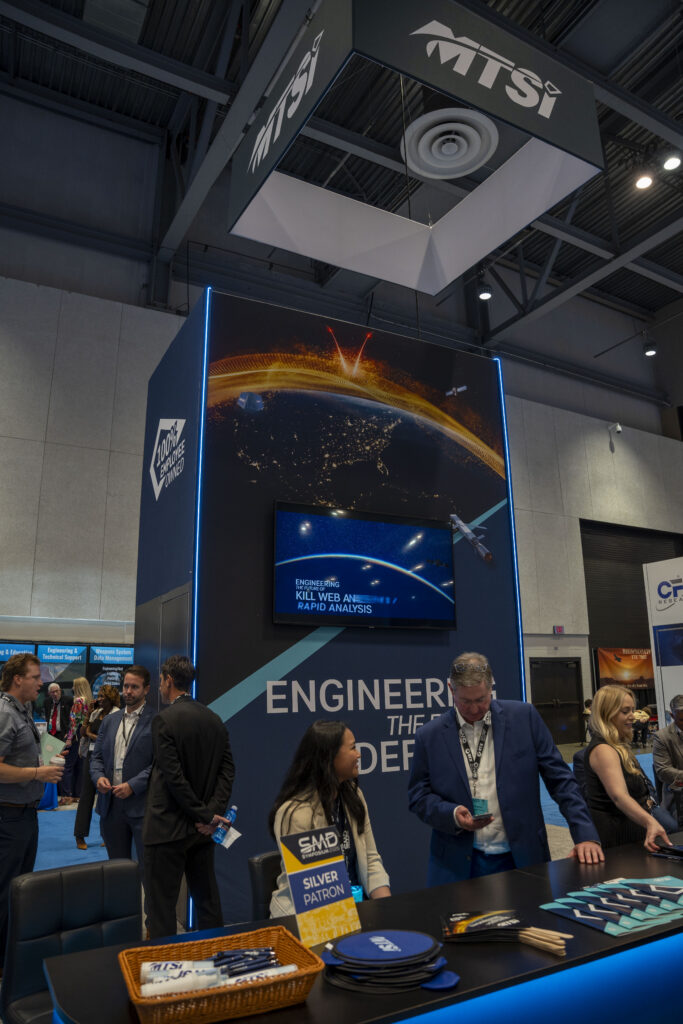 MTSI defense industry trade show booth featuring aerospace and engineering displays.