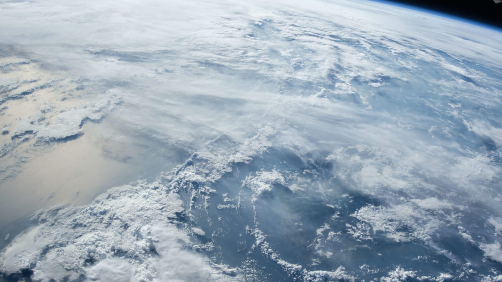 Earth’s atmosphere and cloud formations viewed from space orbit.