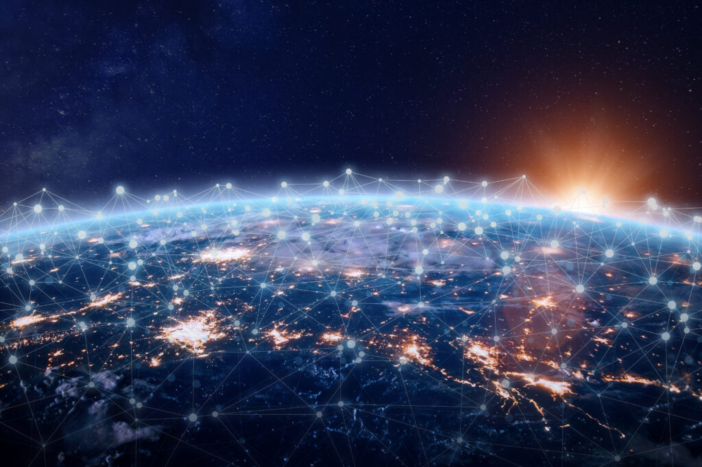 Global digital communications network visualization above Earth at sunrise.