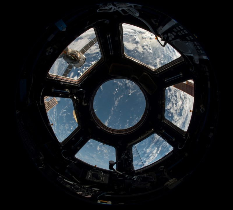 View of Earth through spacecraft observation window from orbit.