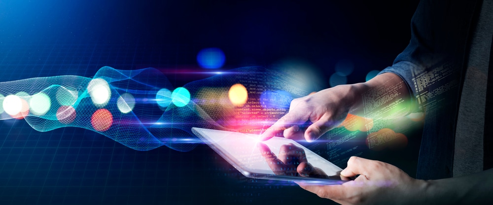 Person interacting with illuminated digital touchscreen interface.